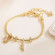 Золотистый браслет с подвесками-талисманами CJL20462