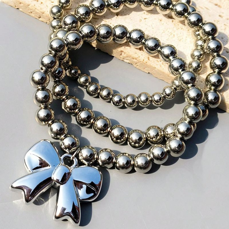 Браслет многорядный из стальных бусин с бантом CJN32391