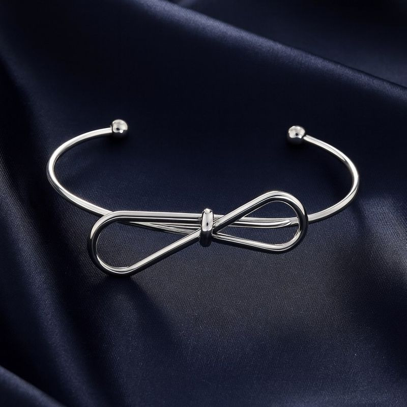 Браслет-кафф с декоративным узлом и сферическими наконежниками 1J12458CJJ