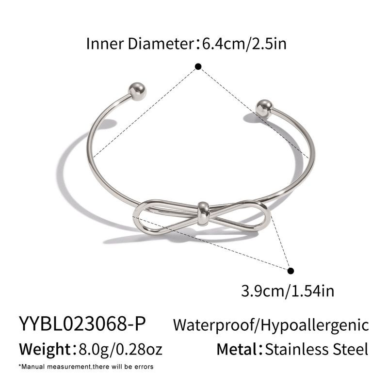Браслет-кафф с декоративным узлом и сферическими наконежниками 1J12458CJJ