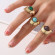 Кольцо с полукруглым веером и зеленым камнем CJL47065