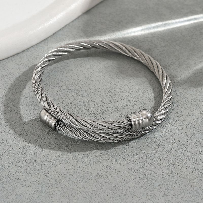 Браслет-жгут из стальных нитей с золотистыми наконечниками CJT17388