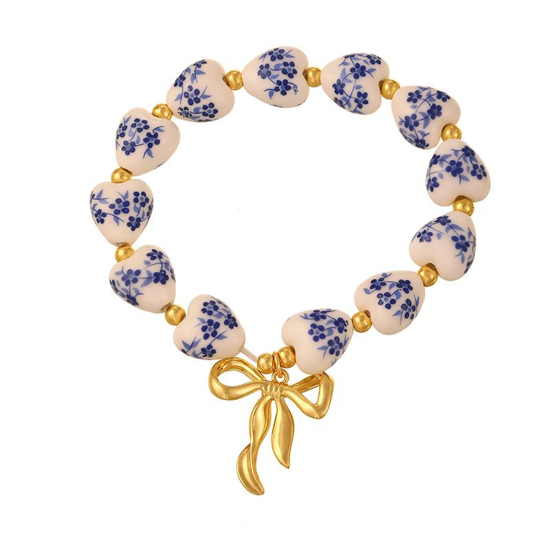 Браслет из узорчатых бусин с крупным жемчугом и бантом CJP64044