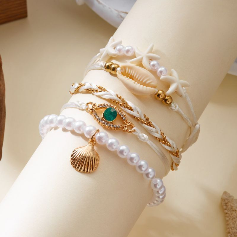 Комплект многорядных браслетов в золотистых тонах CJT06976 Комплект многорядных браслетов в золотистых тонах CJT06976