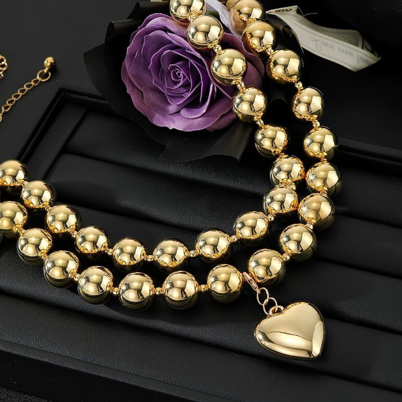 Многослойное колье из золотистых шариков с крупной подвеской-сердцем CJN37603 Многослойное колье из золотистых шариков с крупной подвеской-сердцем CJN37603