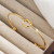 Золотой двухцветный браслет из стали с узлом CJV24453
