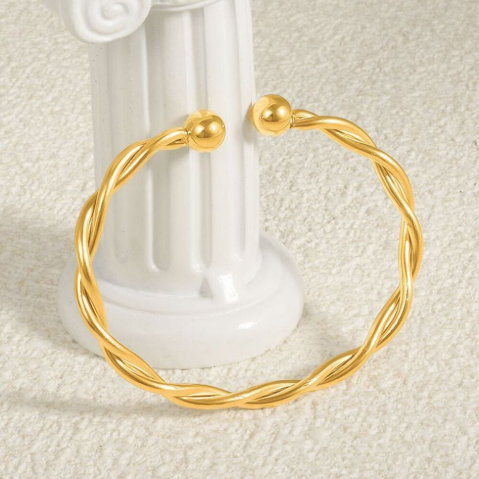 Браслет жесткий витой золотистого цвета с шариками CJH70467