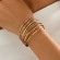 Браслет жесткий многоярусный из тонких золотистых колец CJP93797