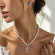 Серебристо-фиолетовое колье с крестом и жемчугом ASUZ46087