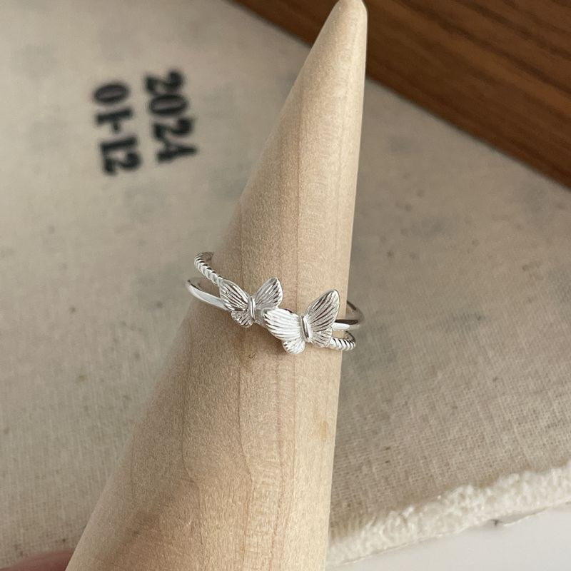 Кольцо с силуэтами бабочек и фианитами 1J11928CJJ Кольцо с силуэтами бабочек и фианитами 1J11928CJJ