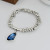 Браслет из серебристых бусин с синим кристаллом CJT25645