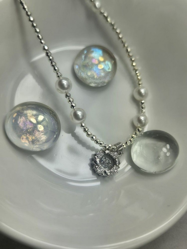 Серебристое колье с жемчужными вставками и круглым кулоном-монетой J10735CJJ Серебристое колье с жемчужными вставками и круглым кулоном-монетой J10735CJJ