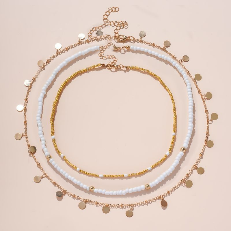 Многослойное колье с россыпью золотистых дисков CJG34590