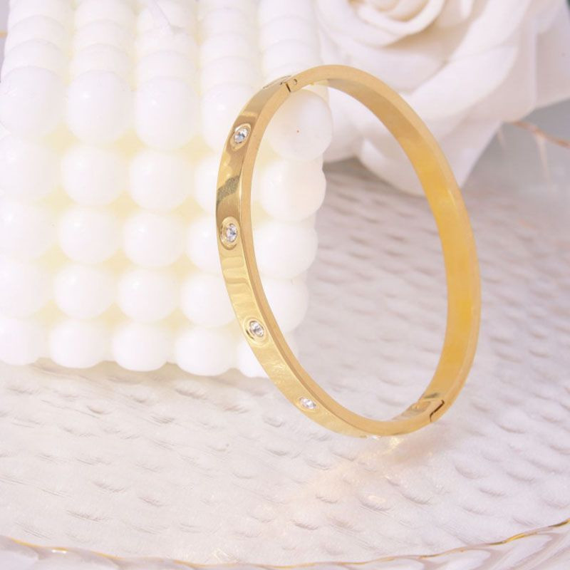 Браслет жесткий золотистый с символичной гравировкой CJL17748