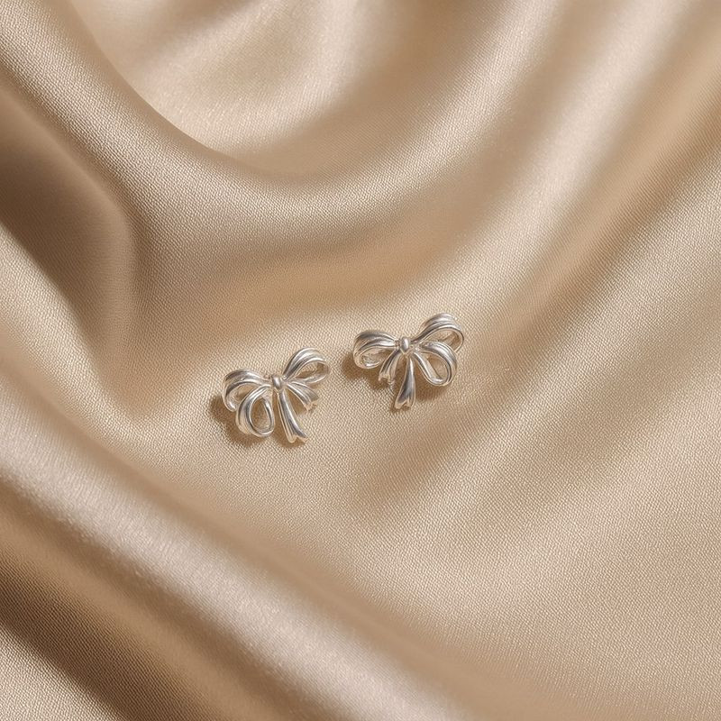 Серьги-гвоздики бантики медь напыление платиной 1J12405CJJ